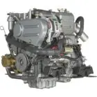 A Yanmar diesel engine with various components and hoses attached.
