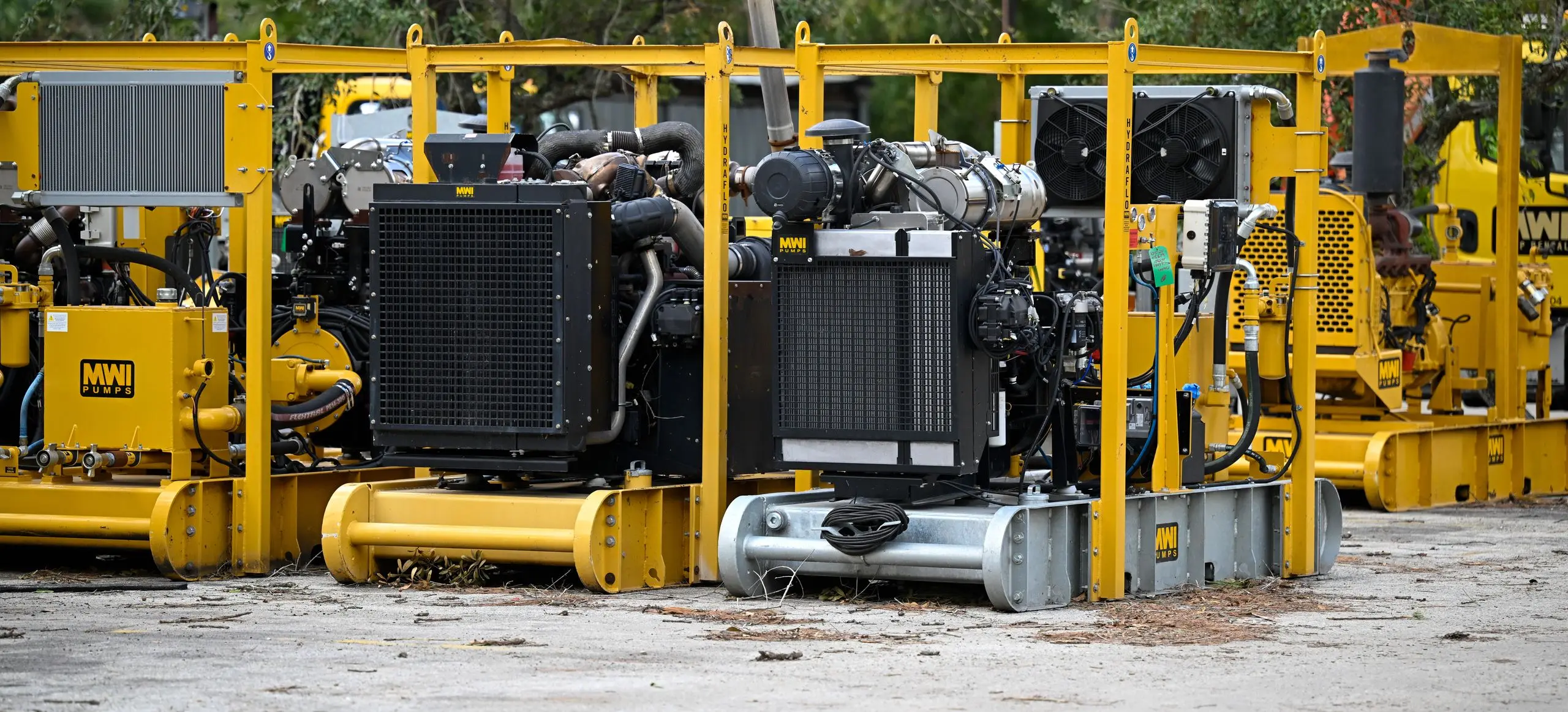 A row of YANMAR-powered MWI pump units lined up in a yard