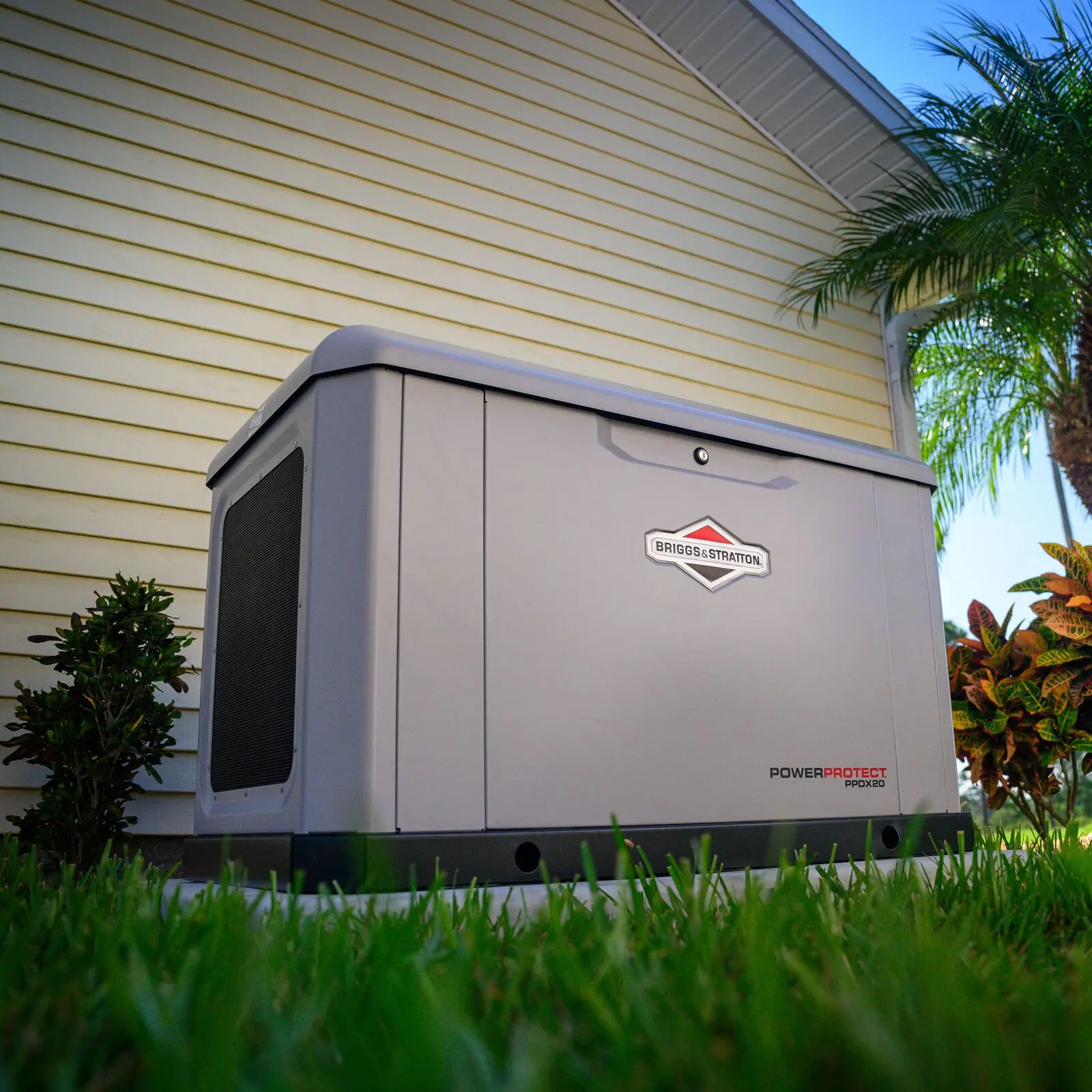 A Briggs & Stratton PowerProtect standby generator on its pad beside a home