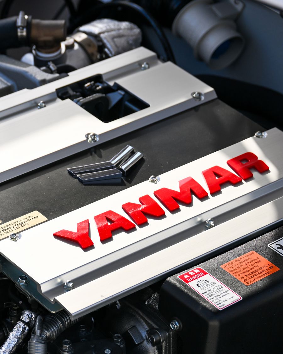 The YANMAR cover on a marine diesel in a powerboat engine room, close up